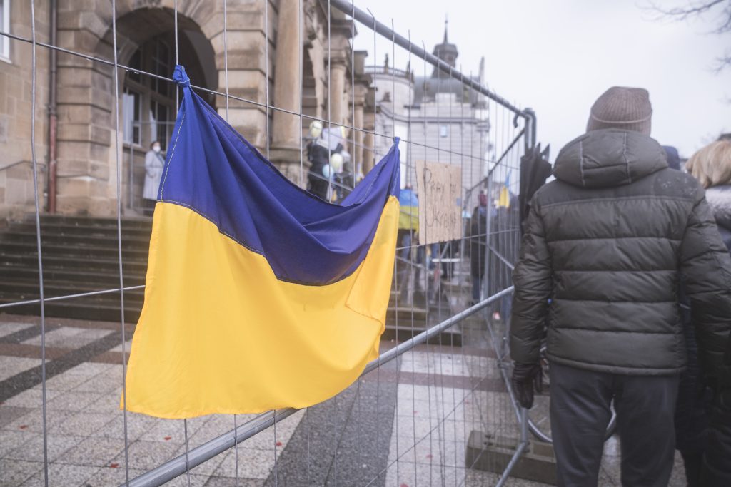 a ukraine flag is hanging on a fence