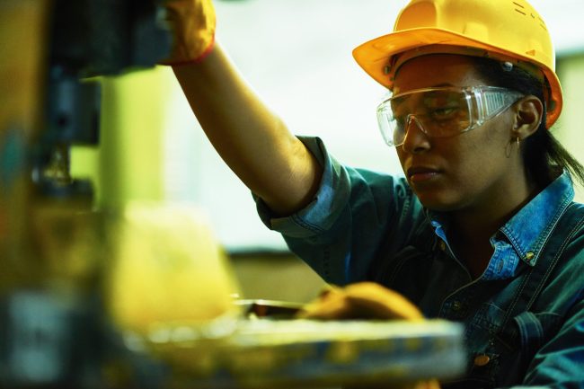 a woman wearing safety goggles and a hard hat