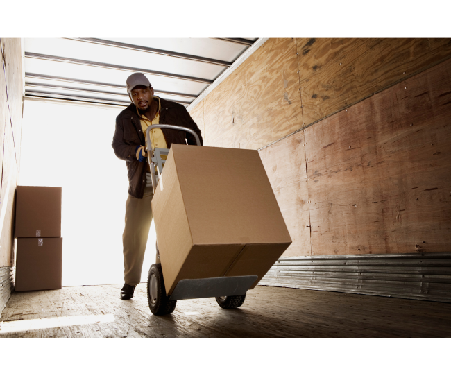 a man pushing a cart with a box on it