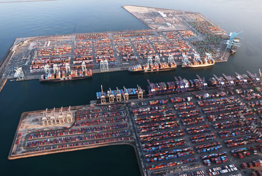 an aerial view of a harbor with a lot of shipping containers